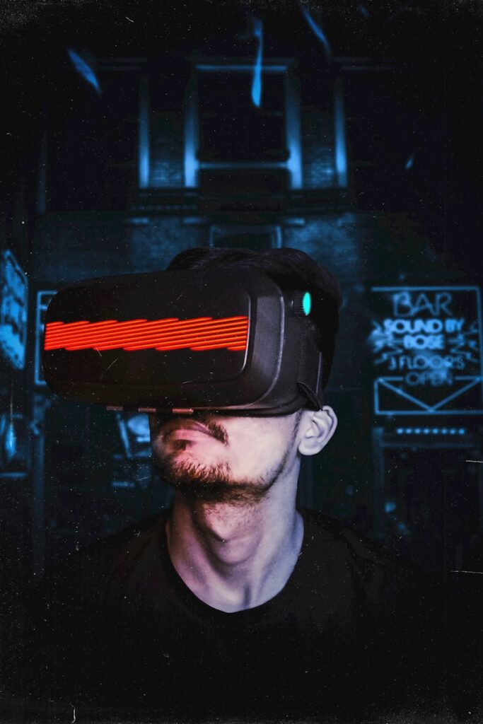 Young man immersed in a virtual reality experience using a VR headset, showcasing futuristic tech in a gaming environment.