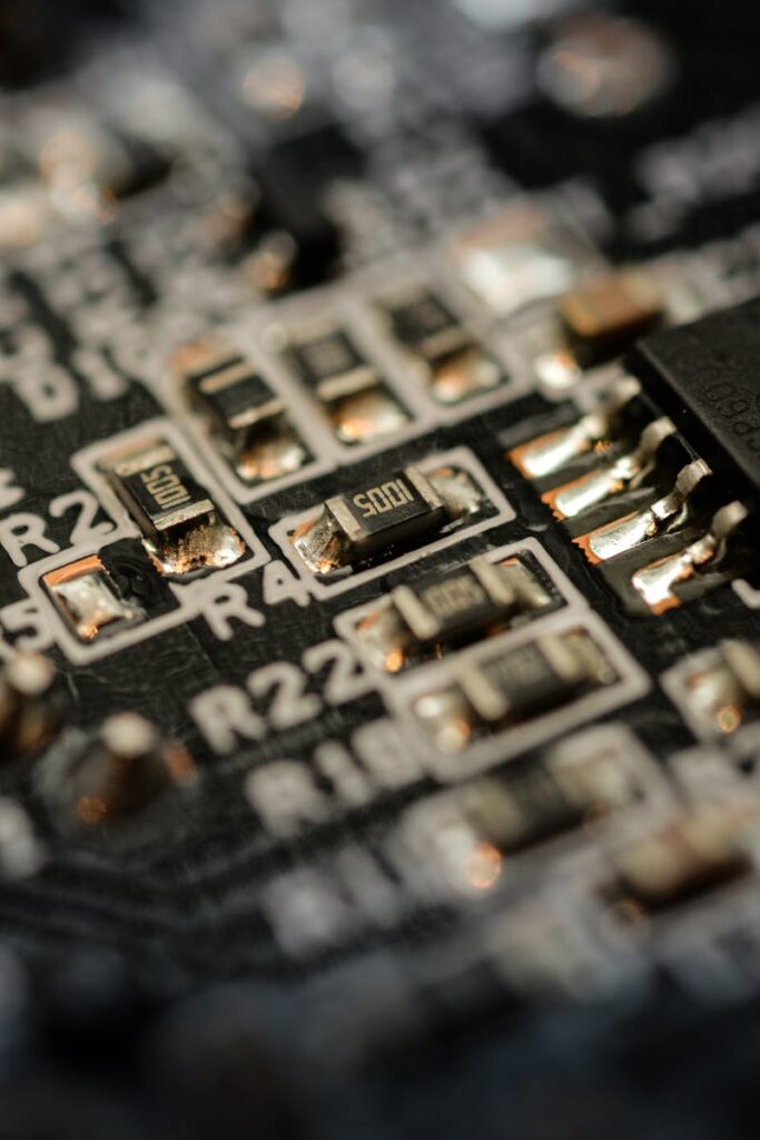 Detailed close-up of a microchip on an electronic circuit board with components and connections.